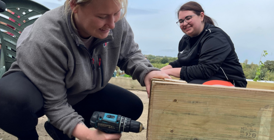 Hinckley & Rugby Building Society colleagues building a raised bed at Weddington Allotment Association.