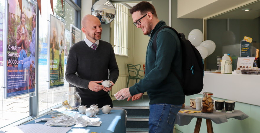 Photograph of a member in a Hinckley & Rugby Building Society branch talking to a staff member.